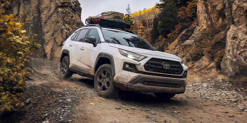 Used Toyota SUV driving through rugged terrain built for adventure.