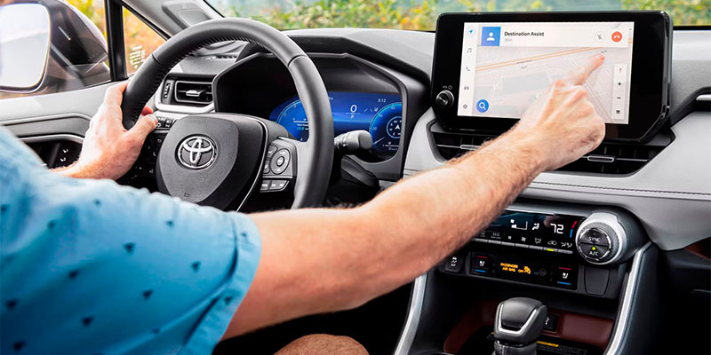 Explore Toyota Safety Sense. A man interacting with Toyota car infotainment